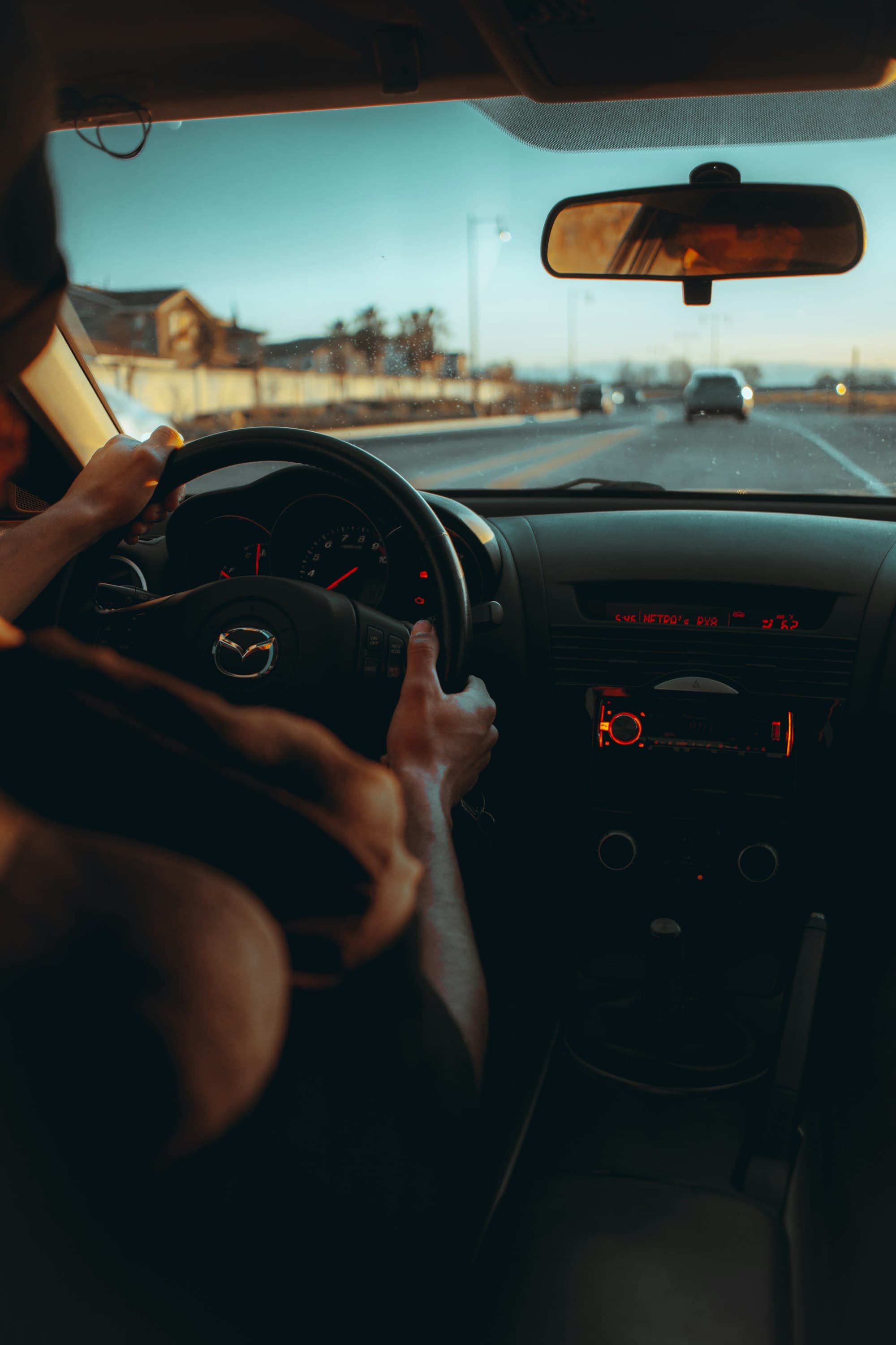 A driver on the highway, hands on the wheel